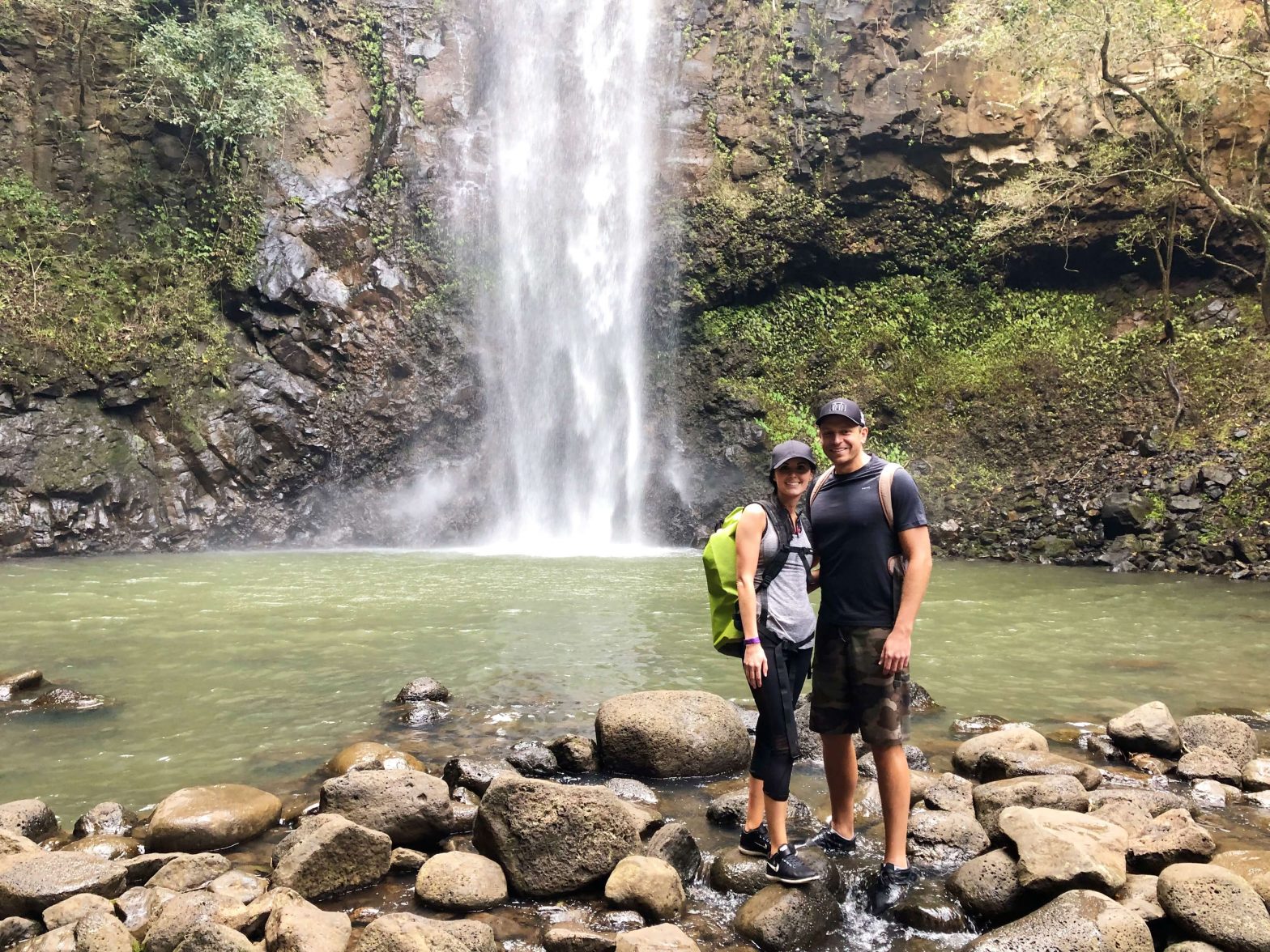 Couple standing in front of waterfall in Kauai. Used Chase Ultimate Rewards for this free trip.