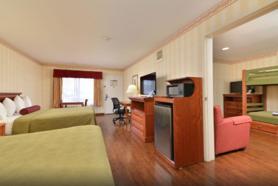 Best Western Raffles Inn & Suites with 2 queen beds and a separate room with bunk beds.