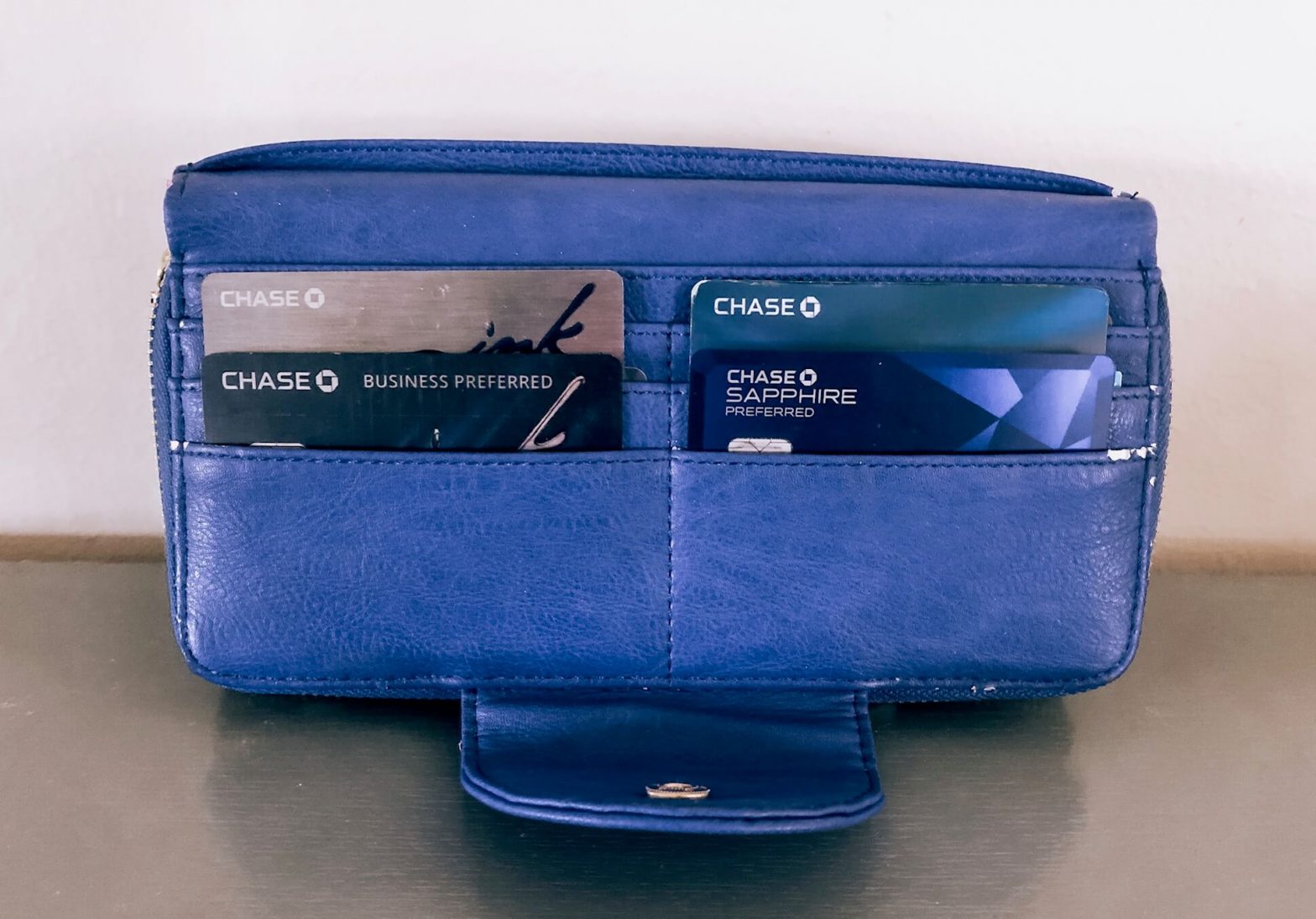 blue wallet holding 4 chase credit cards