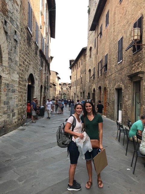 Two women standing in the streets of San Gimignano, Italy