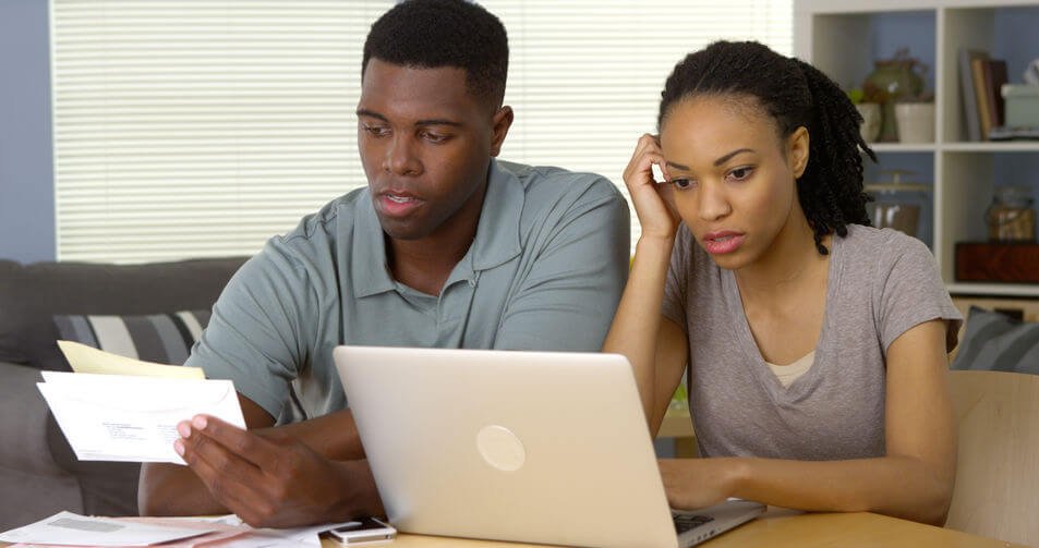 Couple in front of computer paying bills