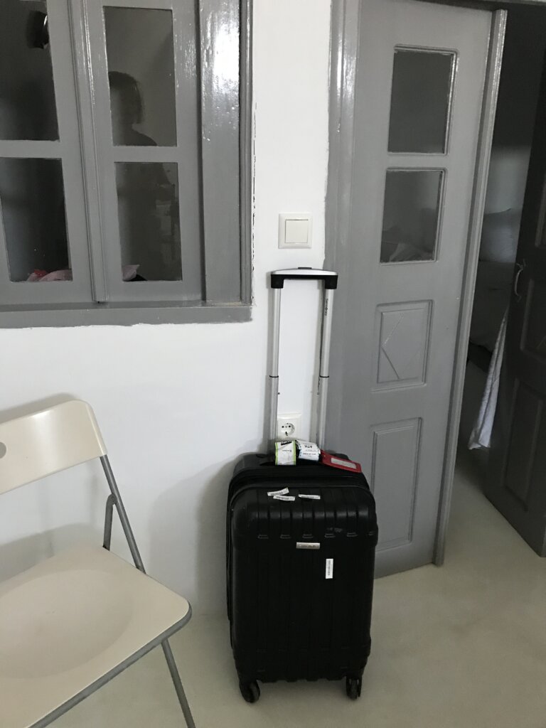 luggage against grey wall