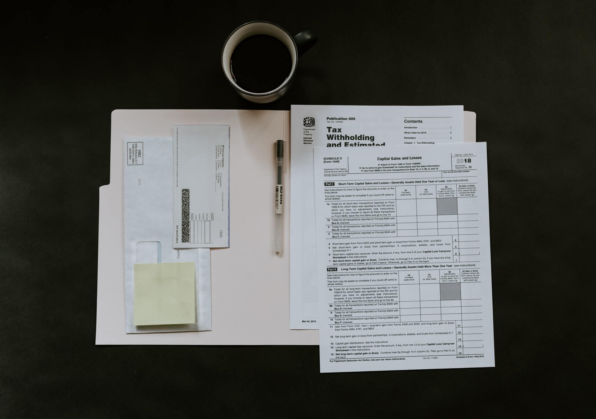 Folder, Federal taxes, pen, etc on desk