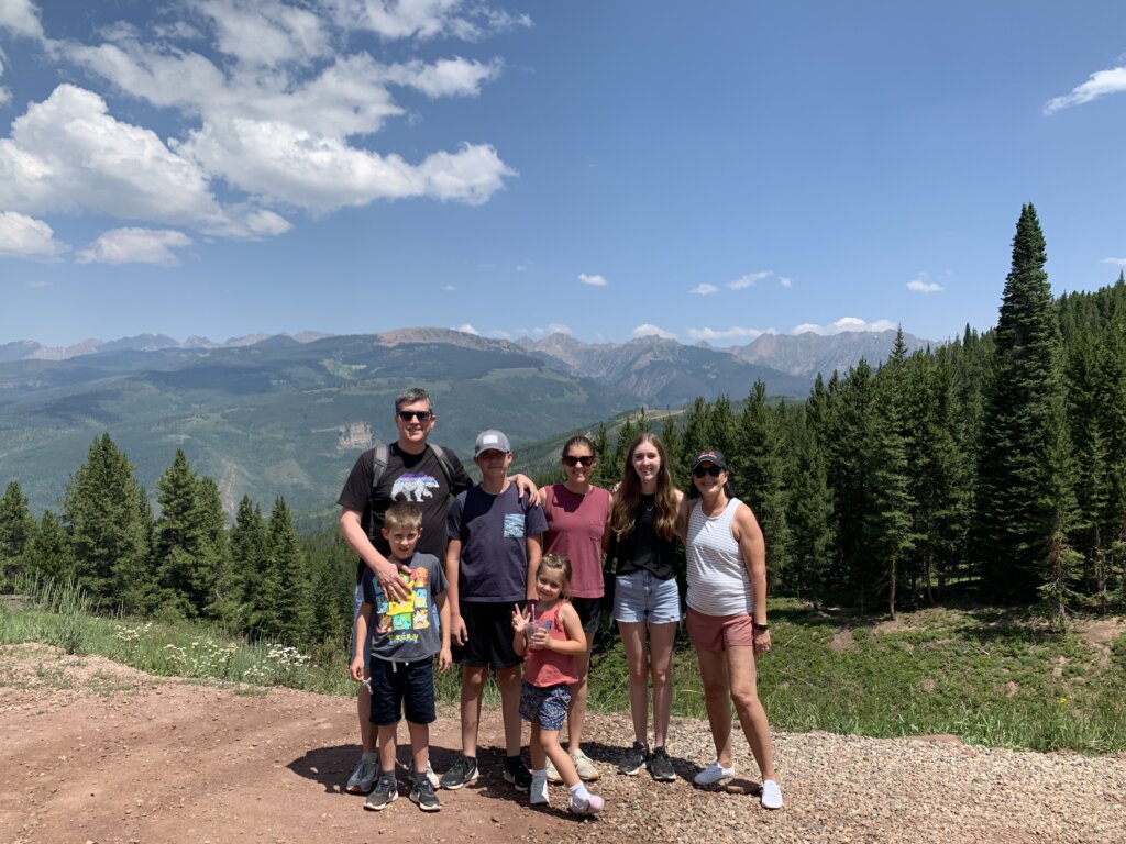 Family standing in front of mountain views