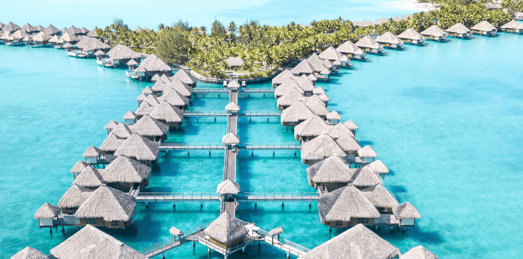 Overwater bungalows over turquoise water