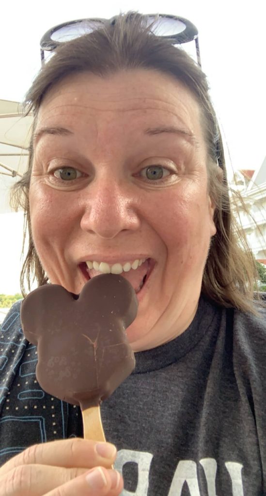 Woman eating chocolate shaped like mouse