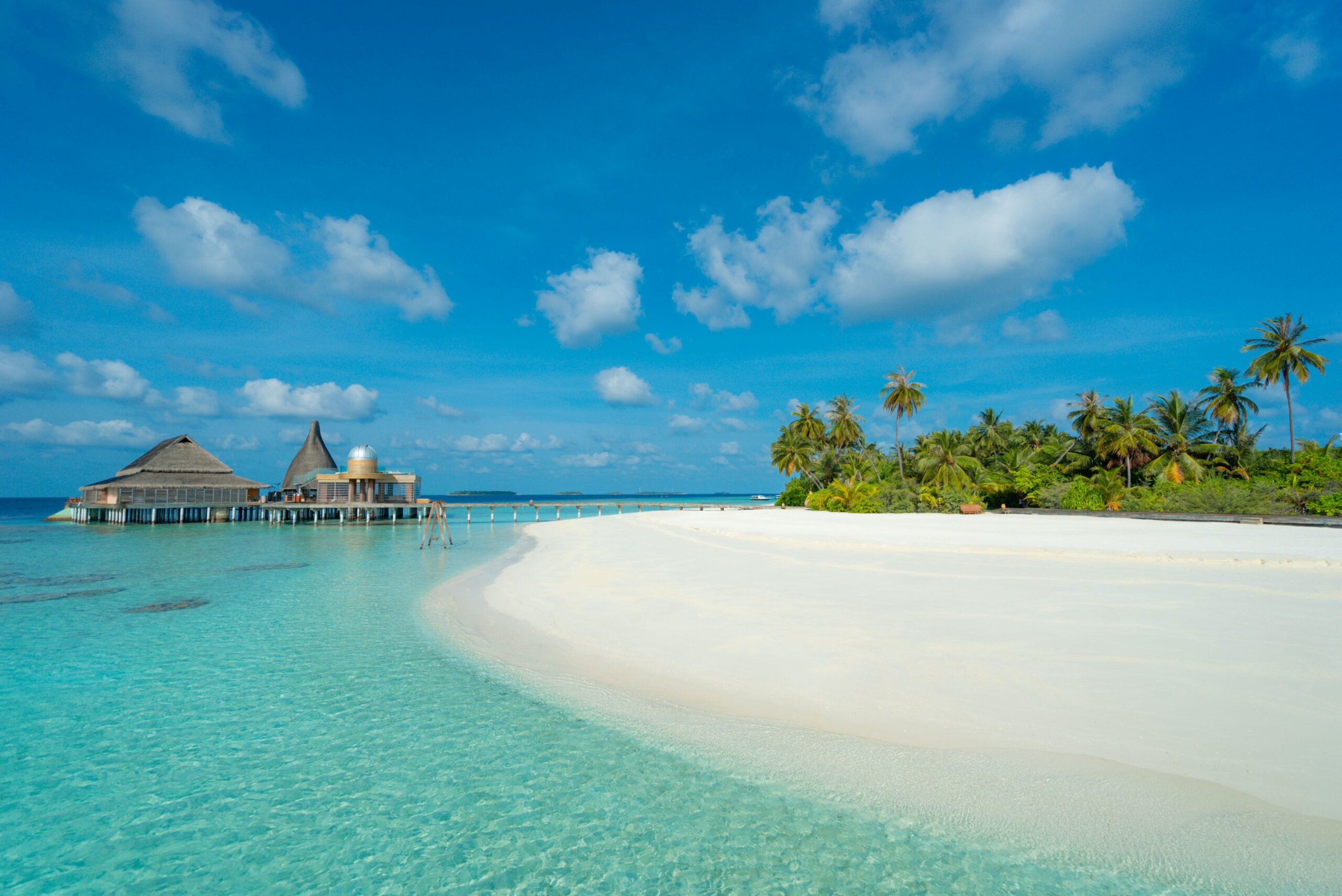 Overwater bungalow near white sand and turquoise water