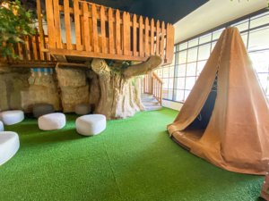 Green grass with fort and teepee