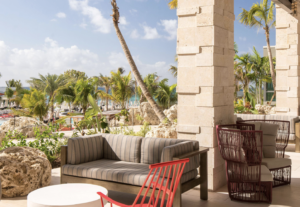 Hotel balcony overlooking palm trees and beach area