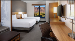 hotel room with 2 queen beds and view of red rocks