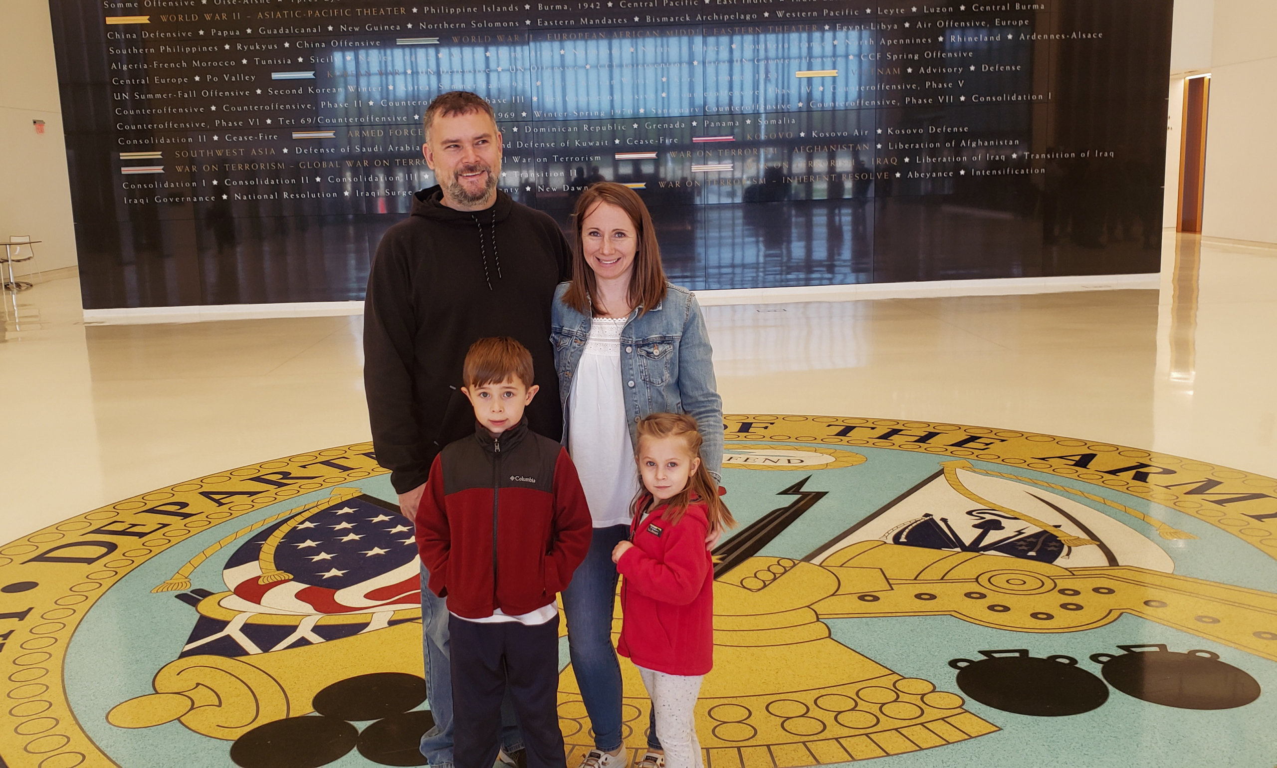 Man, woman, boy and girl standing in museum