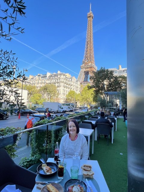 Women at restaurant sitting in front of large tower