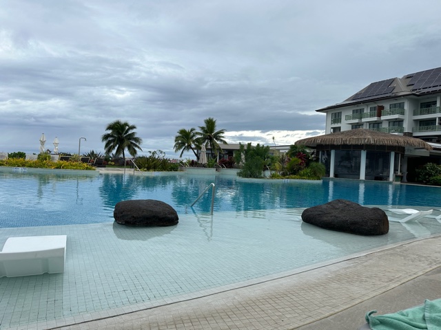 pool area of resort with cloudy skies