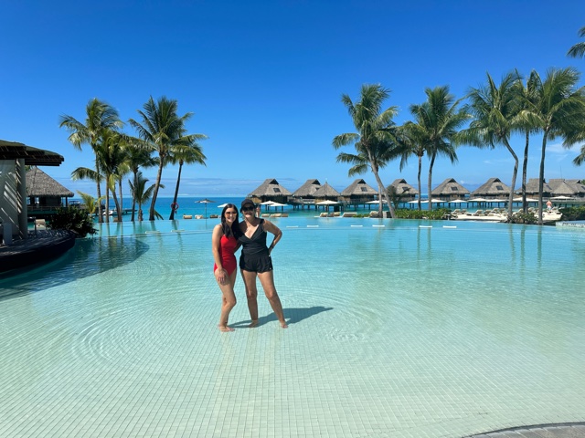 Two women standing in pool