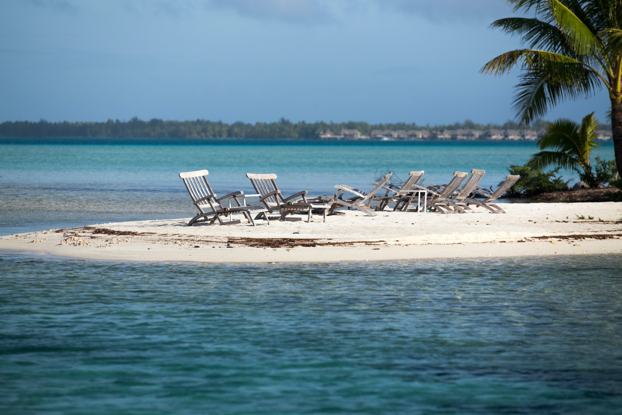 White lounge chairs on sandbar