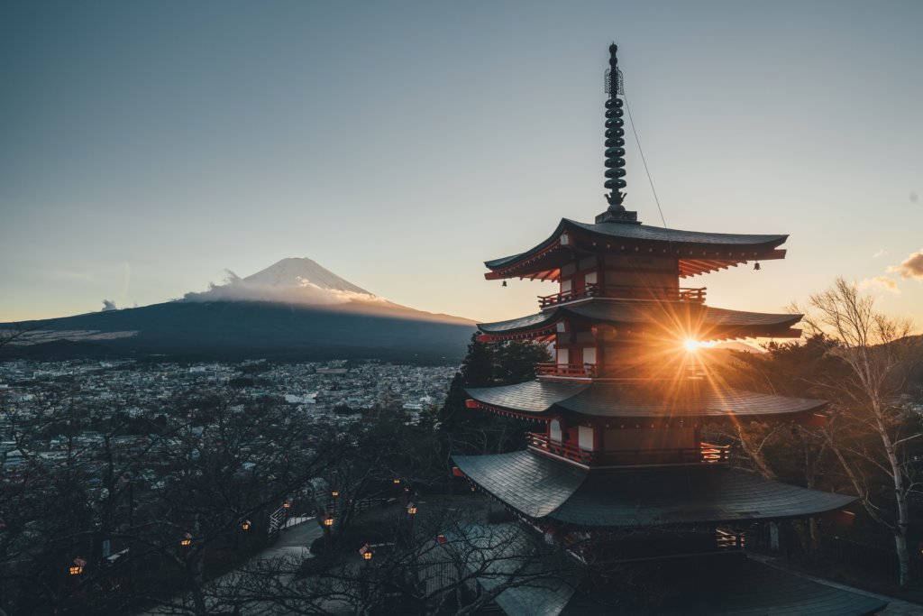 Japanese temple in front of snow covered mountain