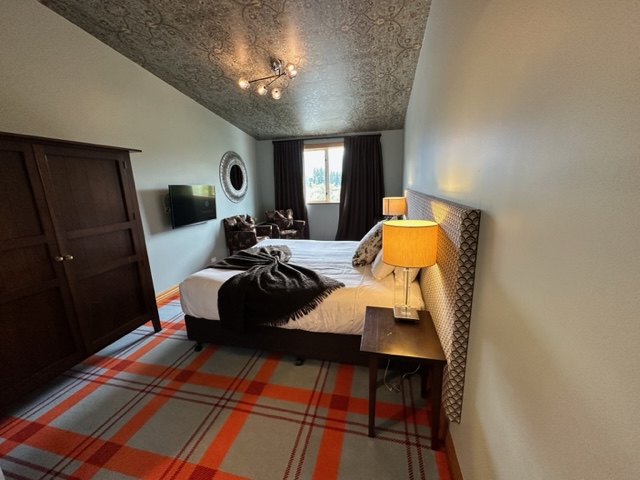 Hotel bedroom with plaid rug