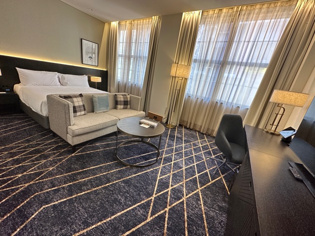 Hotel bedroom with navy rug
