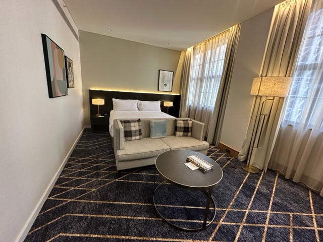 Hotel room with blu plaid rug