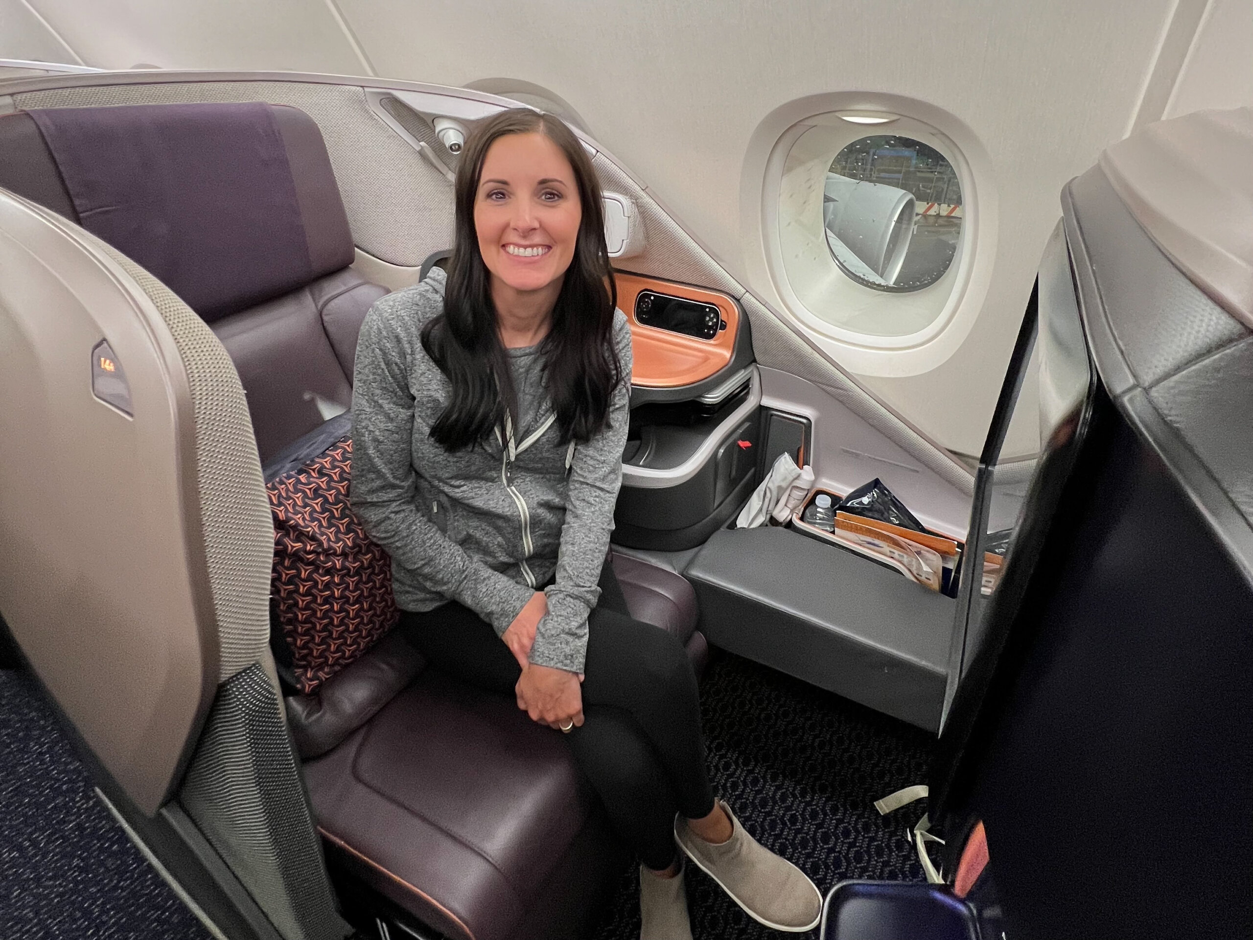 Woman sitting in business class seat on airplane