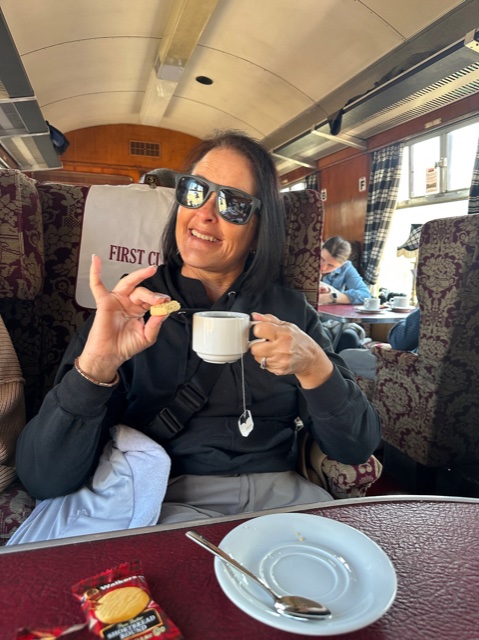 Woman on train with tea
