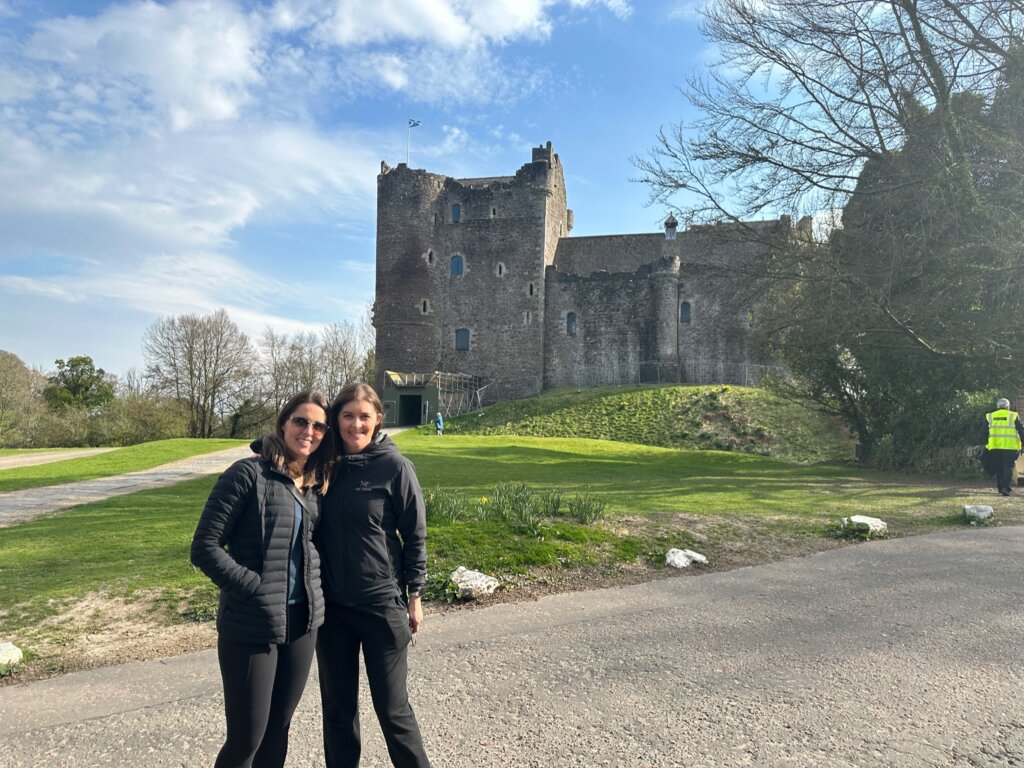 2 women standing near castle
